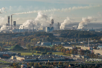 panoramic aerial view of the smoke of pipes as background of huge residential complex with...