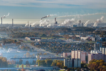 panoramic aerial view of the smoke of pipes as background of huge residential complex with high-rise buildings and private sector . Air and water pollution concept