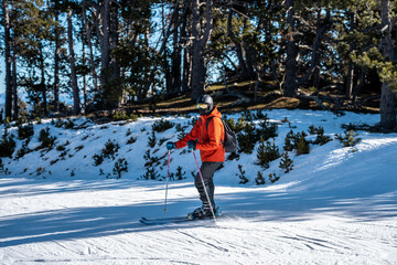 A boy skiing on a ski slope.