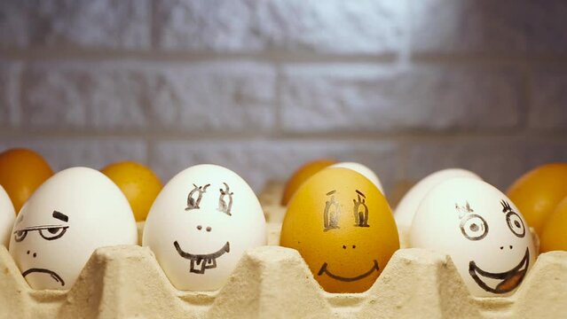 Funny and interesting cartoon faces. Chicken eggs painted in cartoon faces with different grimaces. Chicken eggs under the lamp.	
