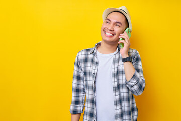 smiling young handsome ethnic Asian man 20s wearing casual clothes talk speaking on a mobile cell...