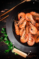 Pot of cooking shrimp with parsley. 