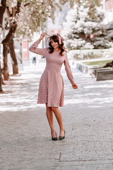 beautiful woman in pink dress with white polka dots