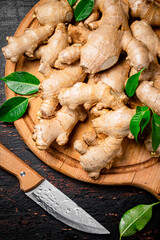 Ginger root on a wooden cutting board. 