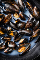 Delicious mussels are boiled in a pot of water. 