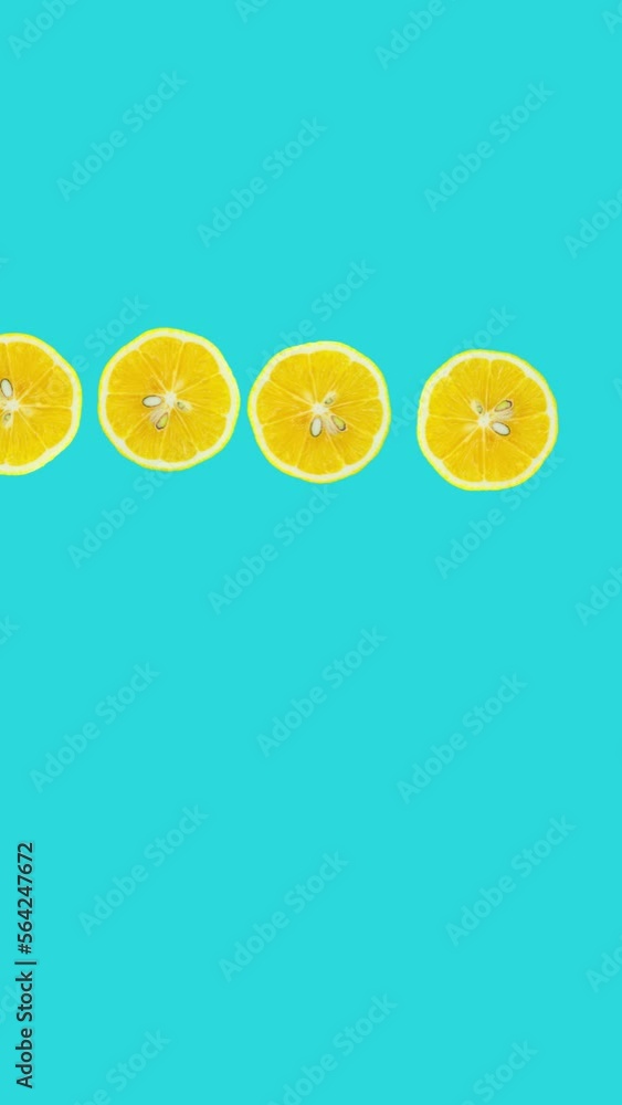 Poster lemon slices rotating on blue background. stop motion citrus animation. healthy eating and refreshme