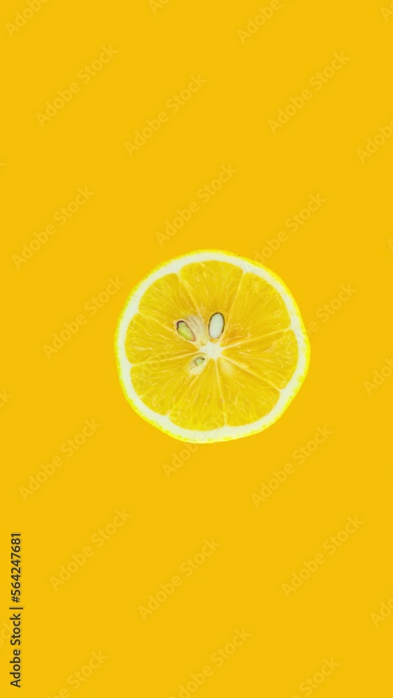 Poster lemon slice rotating on yellow background. stop motion citrus animation. healthy eating and refreshm