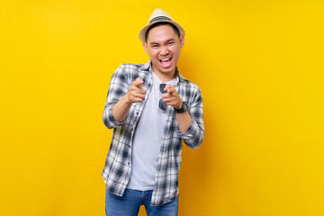 cheerful Young handsome ethnic Asian man 20s wearing casual clothes hat pointing finger at the...