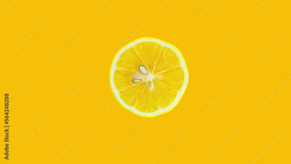 Poster lemon slice rotating on yellow background. stop motion citrus animation. healthy eating and refreshm