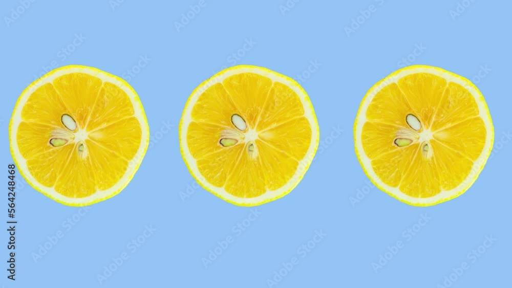 Poster lemon slices rotating on blue background. stop motion citrus animation. healthy eating and refreshme