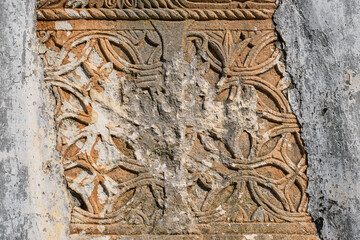 Elements of decor and stone carving with traces of destruction and vandalism, the ghost town of the Greek city of Karmilissos near Fethiye in Turkey