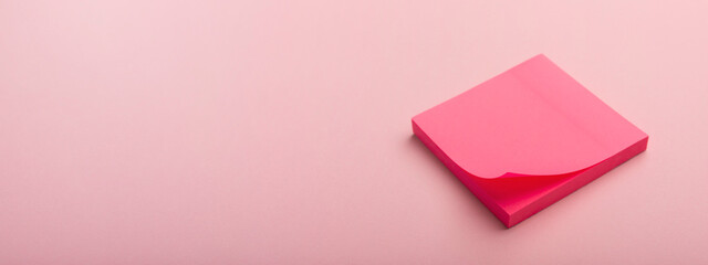 A stack of pink office stickers on a pink background. Planning. Women's business.