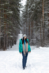 Beautiful young woman in winter forest.