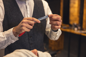 Barber checking the razor sharpness