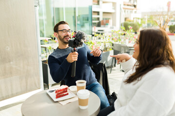 Happy content creator filming his girlfriend on a video vlog