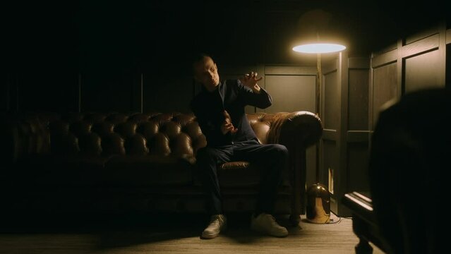 strange mysterious man moving hands like robot, hypnosis and hypnotherapy, portrait of adult man