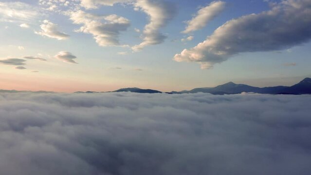 4k drone flight straight-down in to the huge fog footage (Ultra High Definition) of mountains. Picturesque summer view of Carpathian mountains with highest peak - Hoverla..