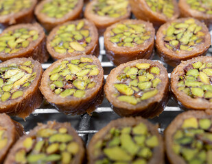 Oriental sweet baklava with honey, pistachio, and other nuts sold in a pastry shop
