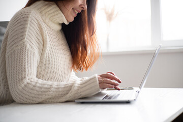 Female hands using laptop keyboard closeup. Home office concept