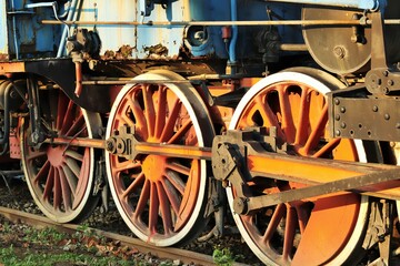 Fototapeta na wymiar Bright wheels of an old steam locomotive