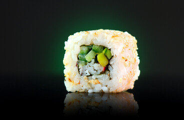 Vegetarian sushi roll Japanese food over dark background. Sushi roll with cucumber, avocado, vegetables closeup. Japan restaurant menu. Vegan 