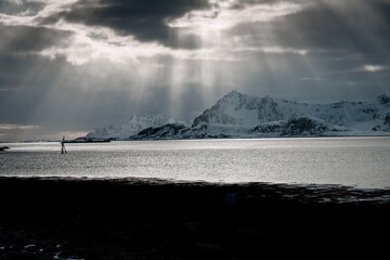 Unbelievable conditions in Lofoten, Norway. Playing lights, sun with clouds with mountains, amazing epic scenery during sunset 