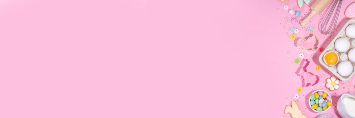Cute pink sweet baking flat lay for Easter holiday. Cooking background with baking ingredients, rolling pin, whisk for whipping, cookie and cutters, sugar sprinkling, flour, top view copy space