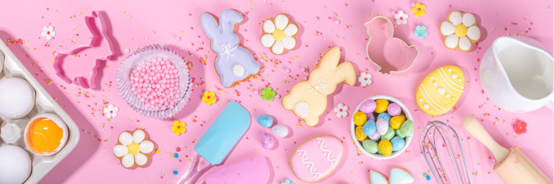 Cute pink sweet baking flat lay for Easter holiday. Cooking background with baking ingredients, rolling pin, whisk for whipping, cookie and cutters, sugar sprinkling, flour, top view copy space