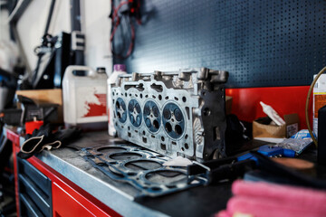 An engine parts on a table at mechanic's shop.