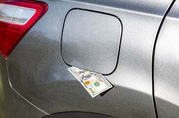 American dollars banknotes in the gas tank of a vehicle