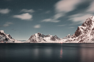 Unbelievable conditions in Lofoten, Norway. Playing lights, sun with clouds with mountains, amazing epic scenery during sunset 