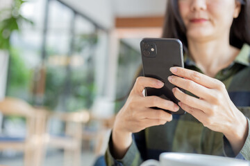 woman using cell phone hand holding mobile texting message contact us.chatting,search internet...