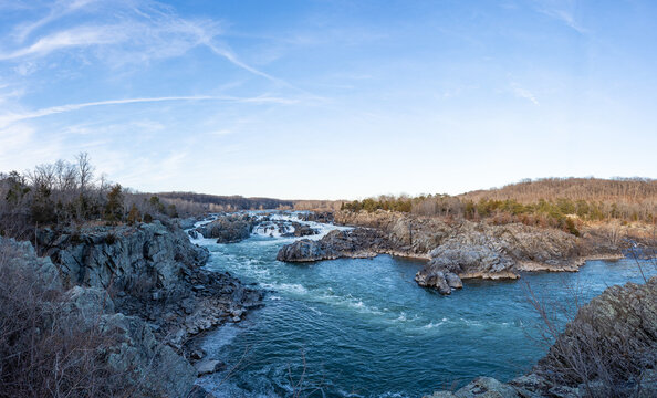 A wide-angle photo of Great Falls National Park in the winter during sunset.