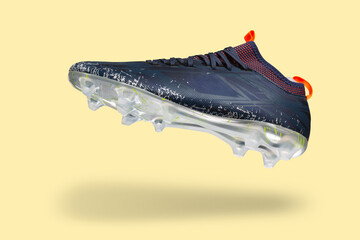 Football shoes levitate, on a yellow background, casting a shadow, concept