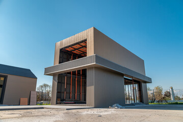 Newly built metal framed building with siding. Construction of a new tiny house. selective focus