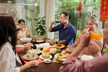 Big family eating dinner together enjoying Chinese New Year celebration