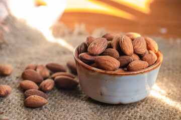 Roasted almonds in a ceramic cup.Warm tone image.