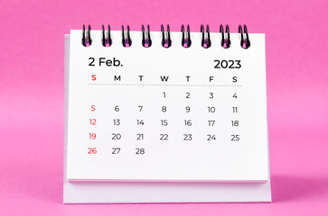 Naklejka na ściany i meble The February 2023 desk calendar on pink color background.