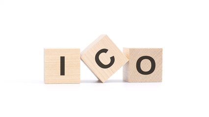 ICO - acronym from wooden blocks with letters, Initial Coin Offering concept, top view on white background