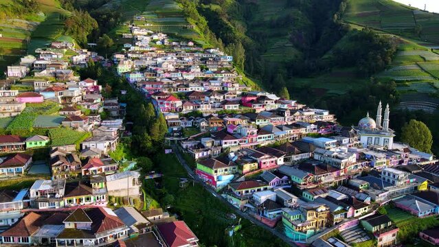 Drone shot of beautiful scenery of village on the slope of mountain with view of terraced houses. Nepal Van Java, Indonesia