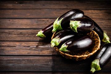 Ripe eggplant in a basket on the table. 