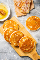 Pancakes on a cutting board with honey. 