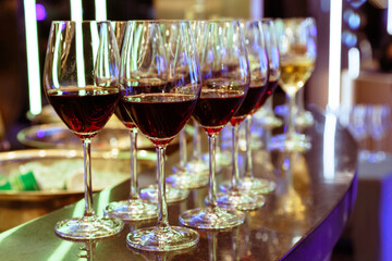 red wine in wine glass on the bar counter ready to serve and drink in the party. celebration and party concept.