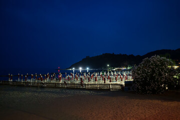 Sun loungers and umbrellas on the beach in Scauri, Italy.