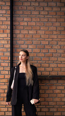 Portrait beautiful business woman model posing on red Brick wall