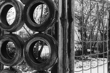 a climbing frame with old car tires - Powered by Adobe