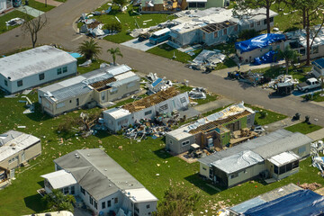 Severely damaged by hurricane Ian houses in Florida mobile home residential area. Consequences of natural disaster