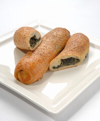 Borek or Turkish patatesli borek. Rolled burek with patato.white background.