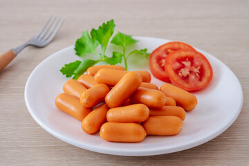 Mini sausage and vegetable on white plate