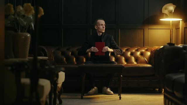 portrait of mysterious man sitting in living room alone and moving like robot, strange mister